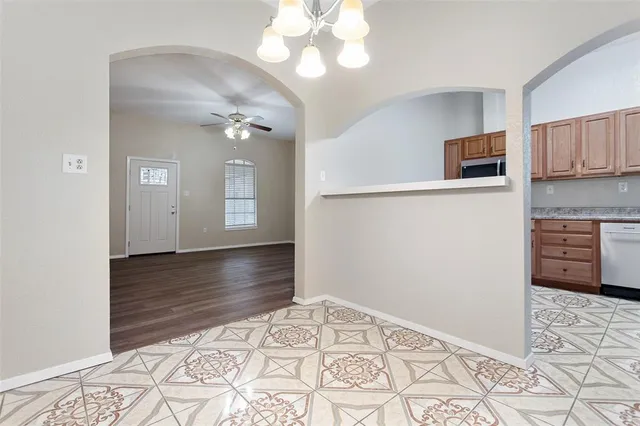 a view of a kitchen with wooden floor and a kitchen space