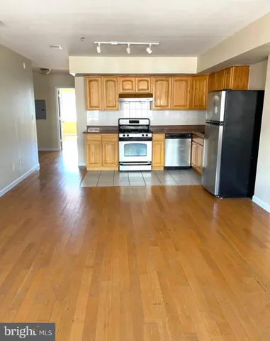 a kitchen with stainless steel appliances a refrigerator and a stove top oven