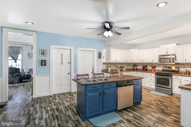 a kitchen with stainless steel appliances granite countertop a refrigerator and a sink