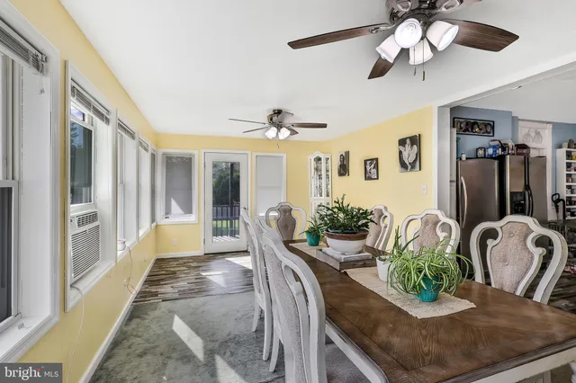 a view of a dining room with furniture and a chandelier fan