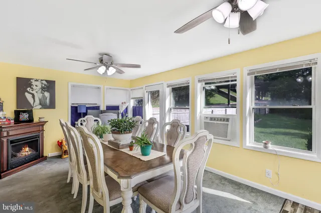 a view of a livingroom with wooden floor and a ceiling fan