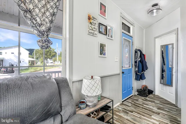 a living room with couches and a chandelier