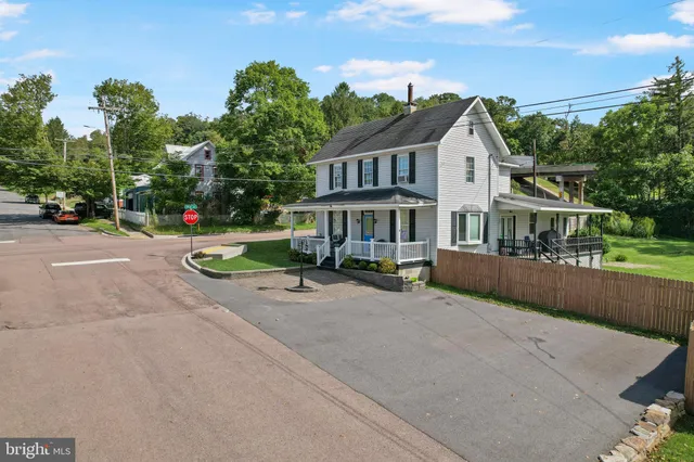 a view of a house with a small yard and a garden