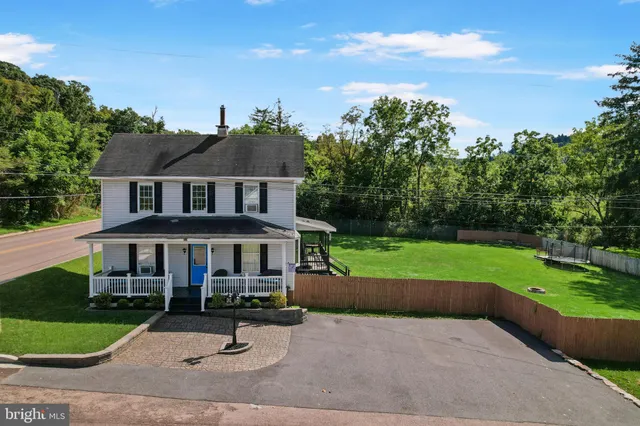 a view of a house with a yard and sitting area