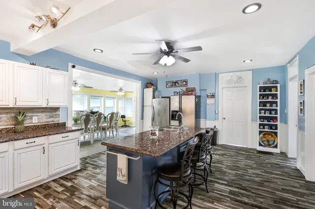 a kitchen with stainless steel appliances granite countertop a sink and a stove