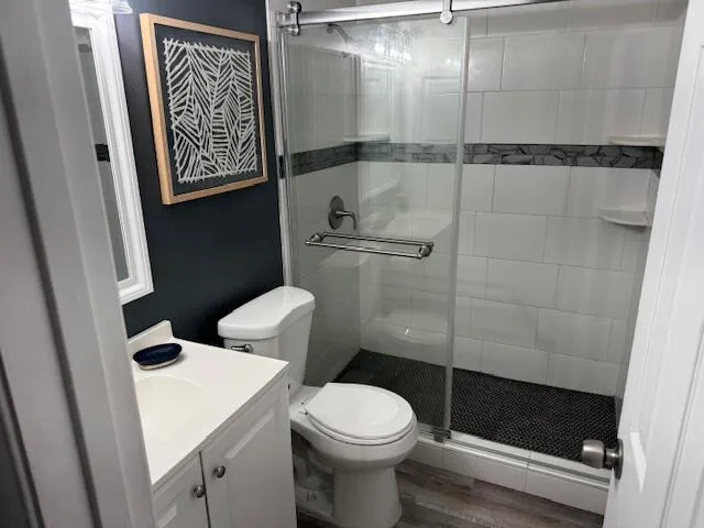 a bathroom with a toilet and a shower