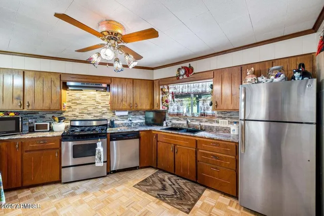 a kitchen with a stove a sink and cabinets