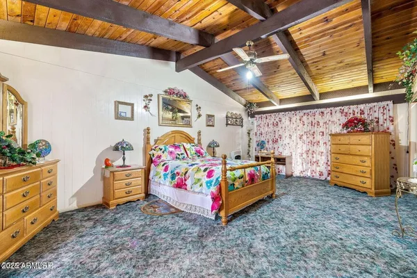 a bed room with a bed and a mirror