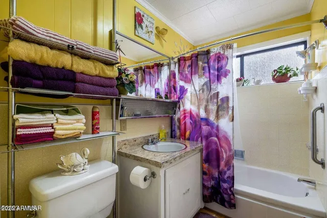 a bedroom with a bed and a mirror on the dresser