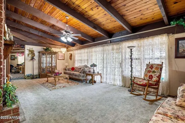 a living room with furniture a rug and a chandelier