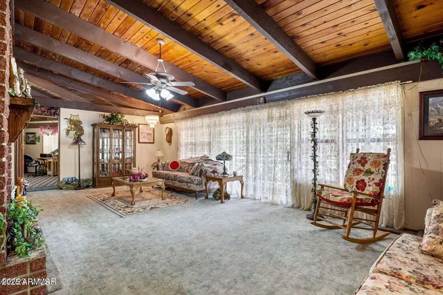 a living room with furniture a rug and a chandelier