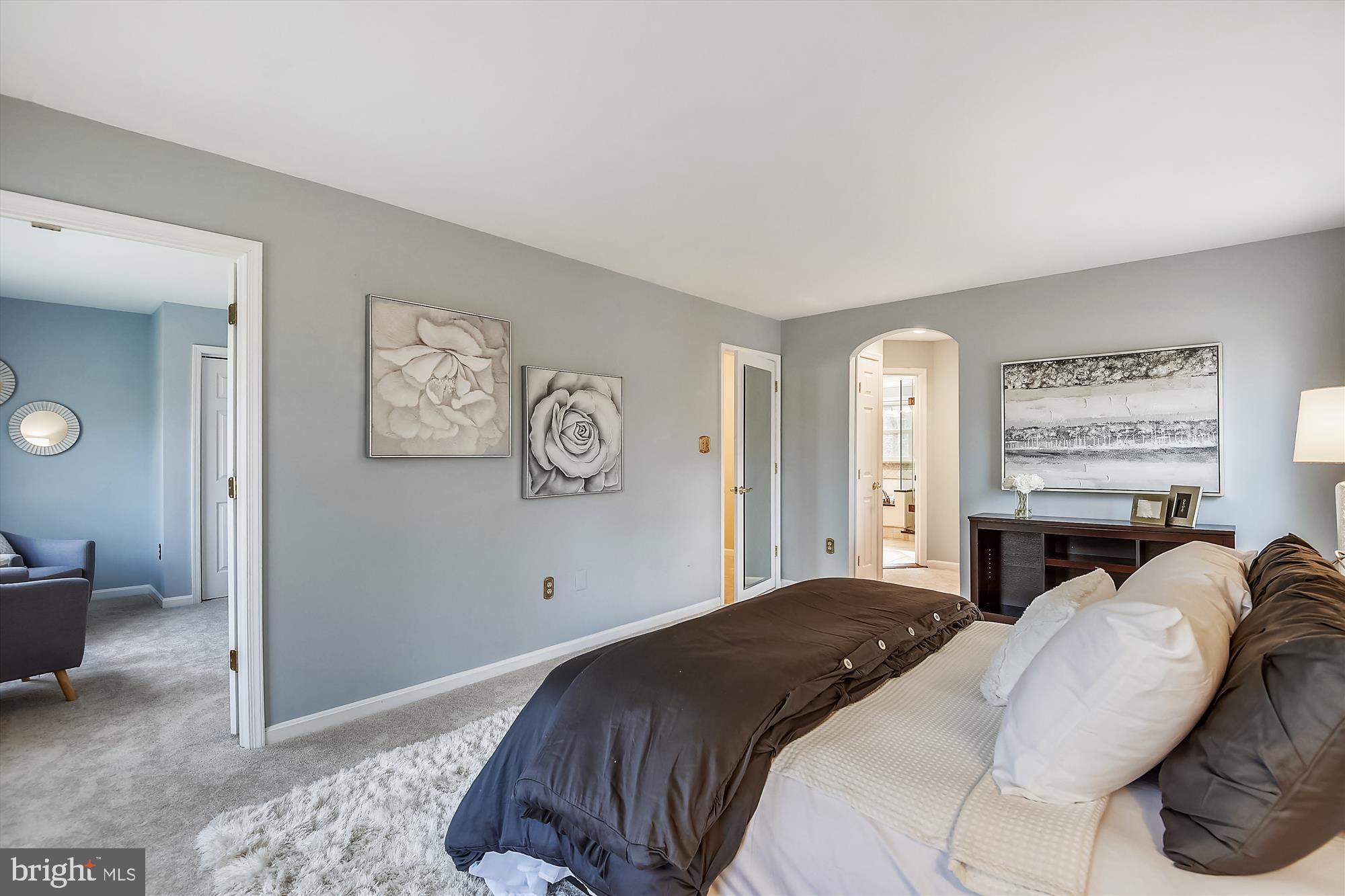 11874 Fawn Ridge Lane Reston, VA 20194 - Photo 41 of 75 a bedroom with a large bed and a chandelier