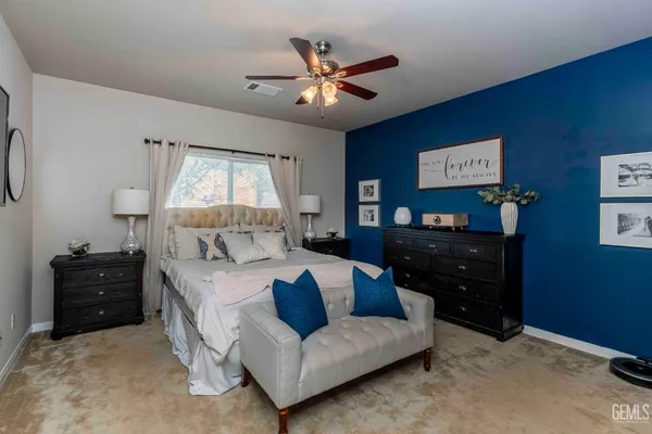 a bed room with a bed window and a dresser