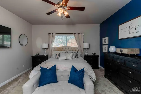 a bedroom with a large bed and a chandelier