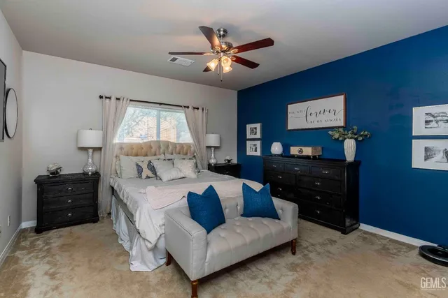 a bed room with a bed window and a dresser