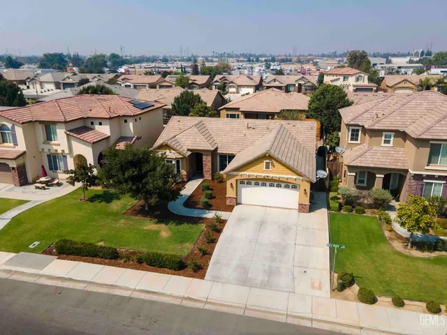 an aerial view of multiple houses with yard