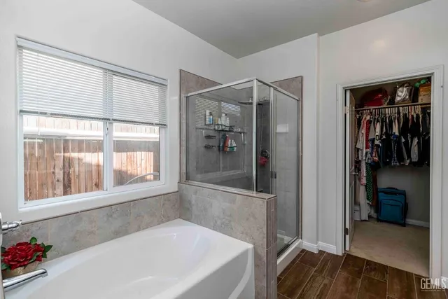 a en suite spacious bathroom with a tub and shower