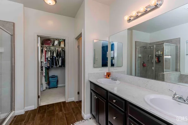 a bathroom with a double vanity sink and a mirror