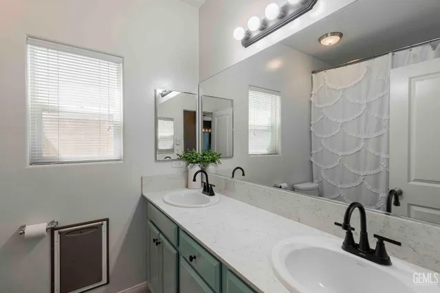 a bathroom with 2 sink and a mirror