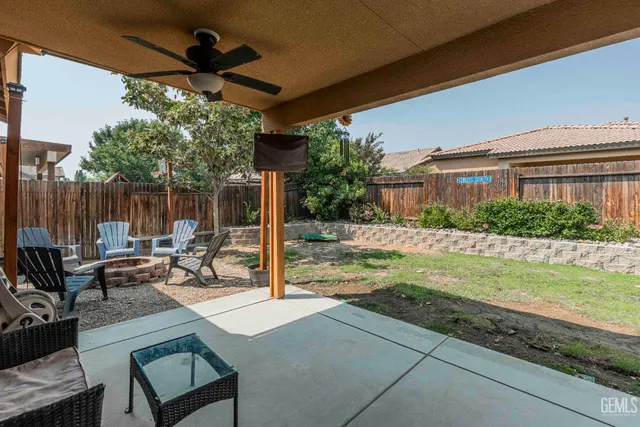 a view of a patio with a table and chairs under an umbrella