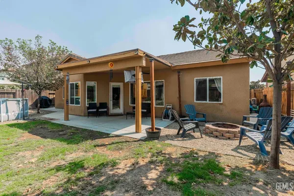 a view of a house with backyard porch and sitting area