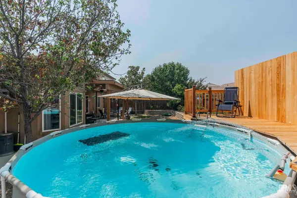 a view of a house with backyard and sitting area