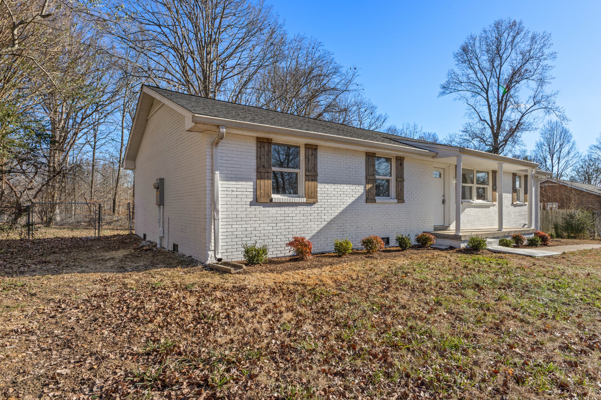 1029 Granada Road Ashland City, TN 37015 - Photo 16 of 34 a backyard of a house with large trees and outdoor seating