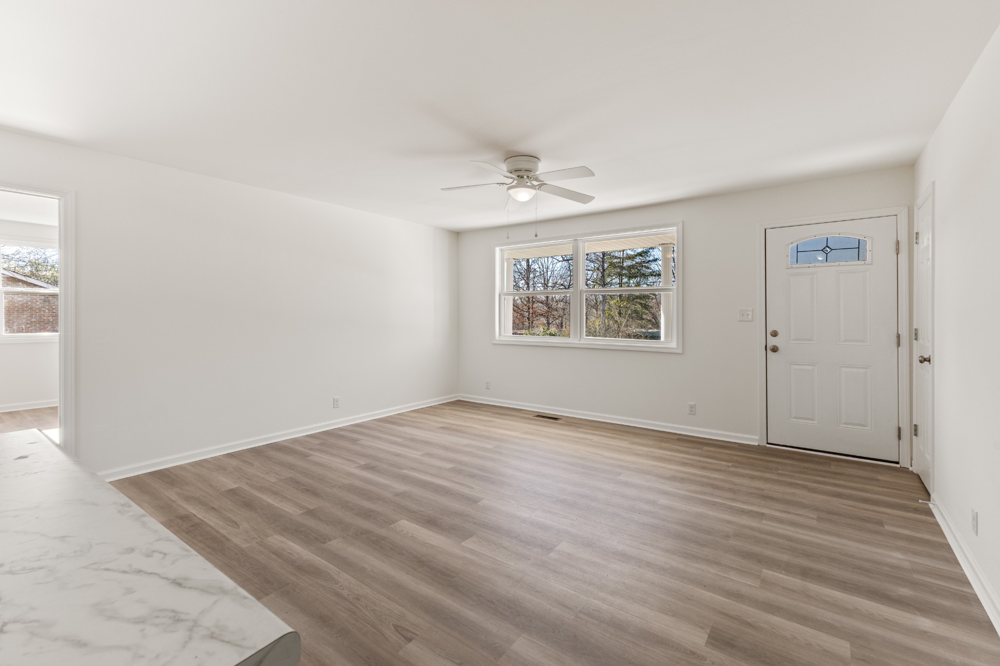 1029 Granada Road Ashland City, TN 37015 - Photo 24 of 34 an empty room with wooden floor and windows