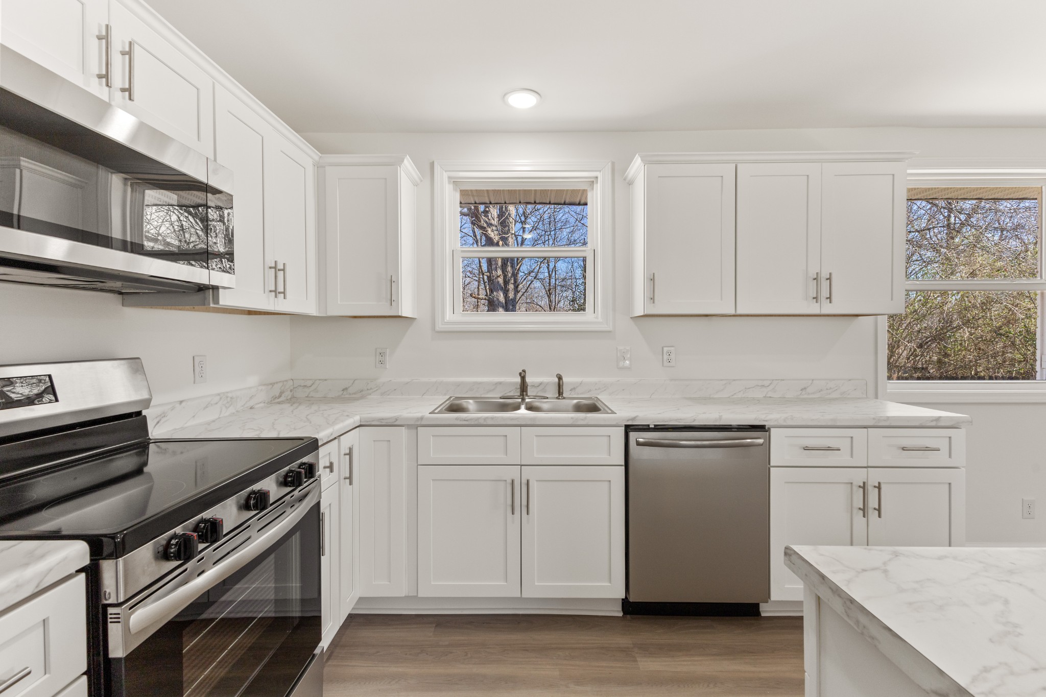 1029 Granada Road Ashland City, TN 37015 - Photo 26 of 34 a kitchen with stainless steel appliances granite countertop a stove and a sink