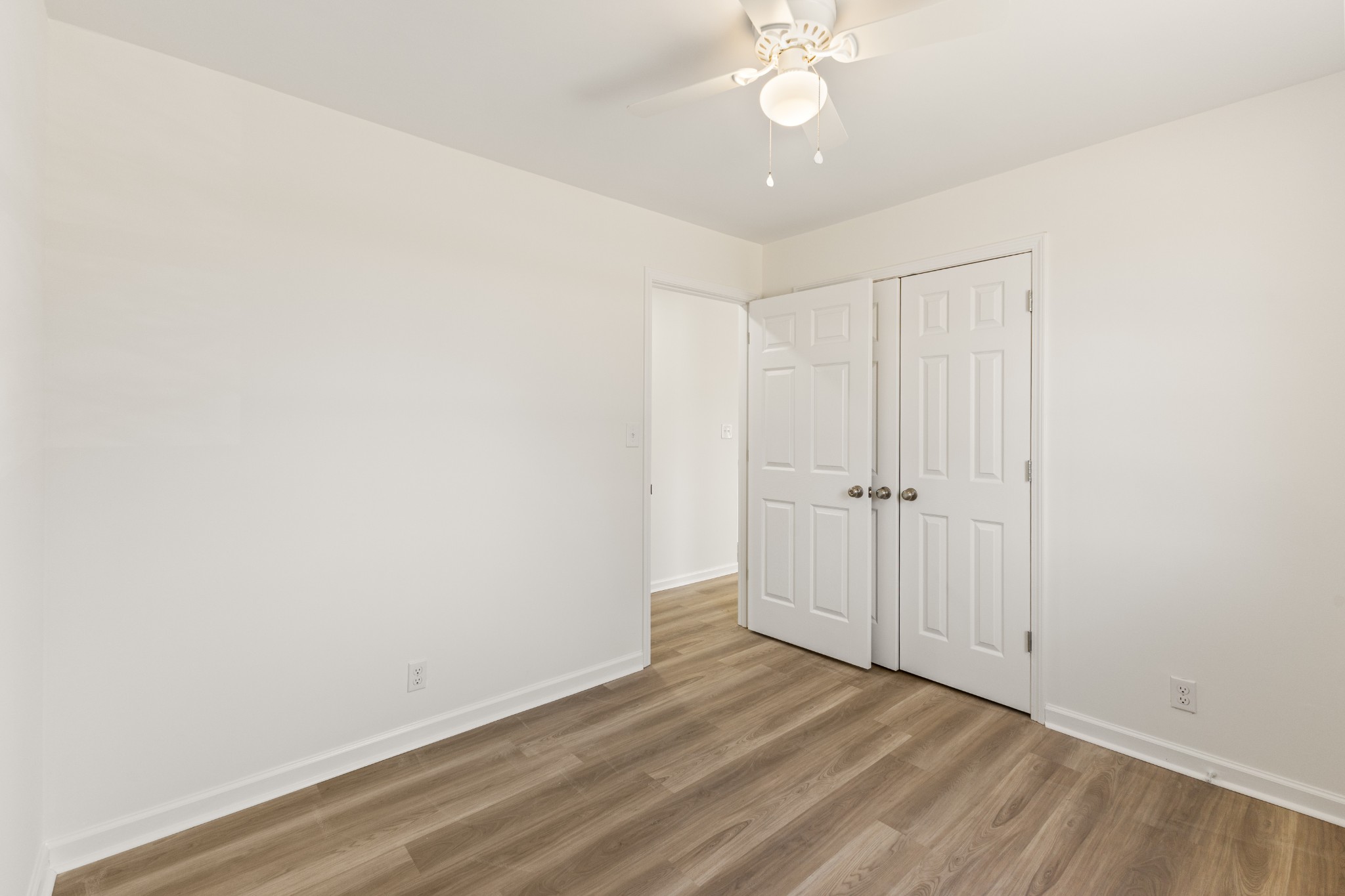 1029 Granada Road Ashland City, TN 37015 - Photo 30 of 34 an empty room with a ceiling fan and wooden floor