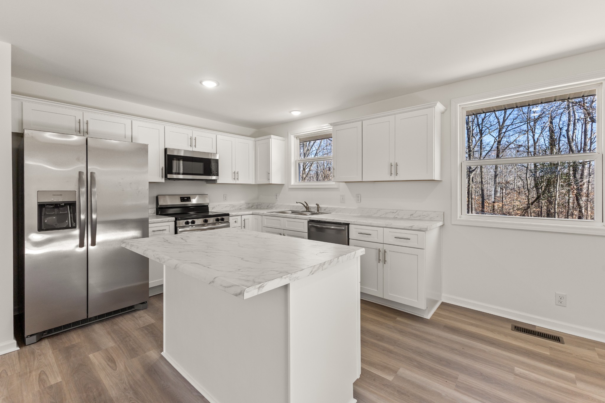 1029 Granada Road Ashland City, TN 37015 - Photo 4 of 34 a kitchen with cabinets stainless steel appliances a sink and a window