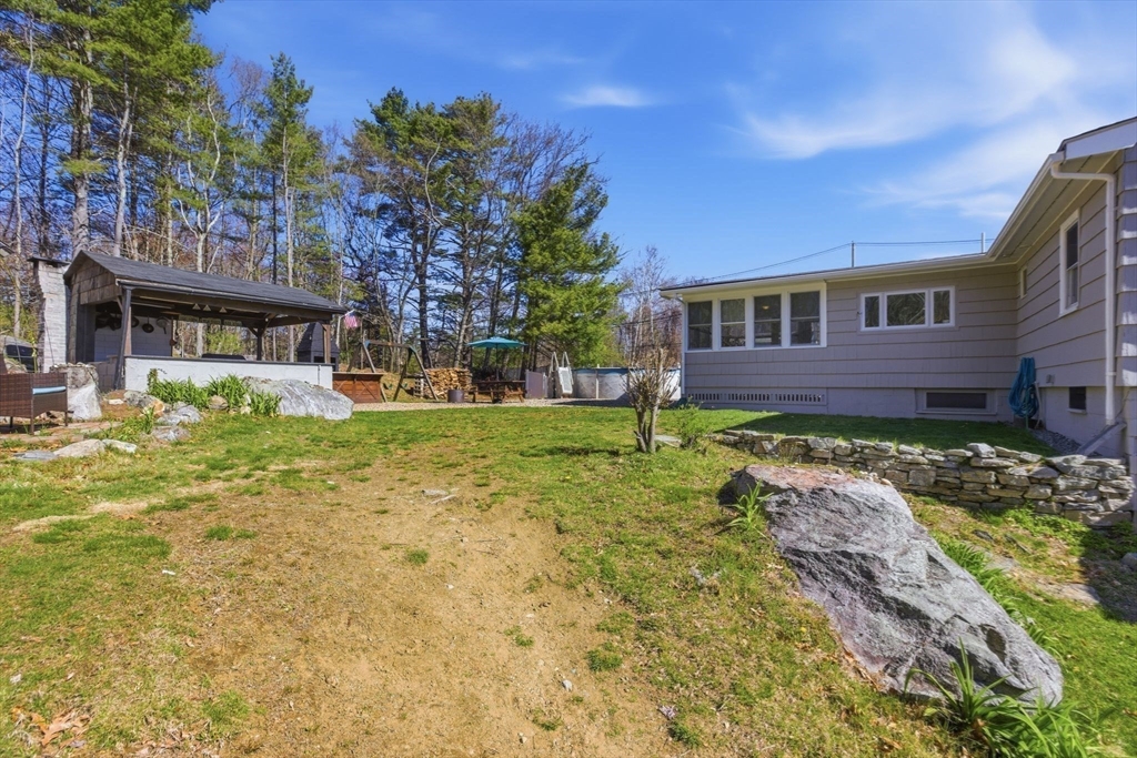 38 Woodland Road Georgetown, MA 01833 - Photo 40 of 42 a front view of a house with a yard