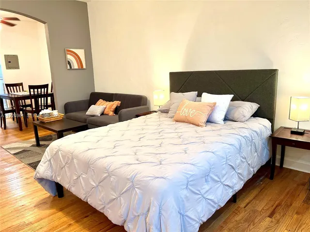 a large bed sitting in a bedroom next to a lamp