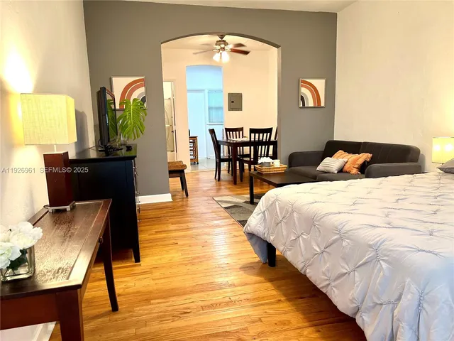 a bedroom with bed and wooden floor