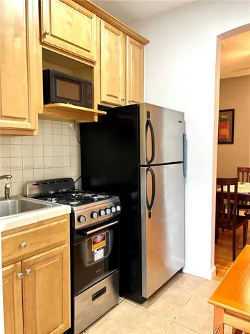a kitchen with a stove and a refrigerator