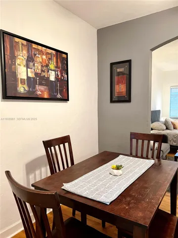 a view of a dining room with furniture wooden floor and window