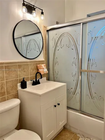 a bathroom with a toilet a sink and a mirror