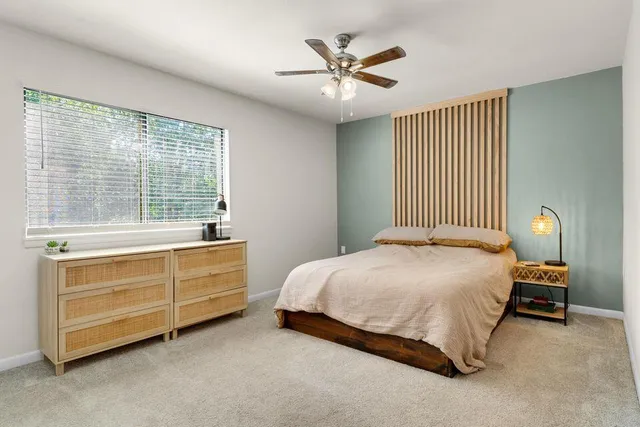 a view of a room with a ceiling fan