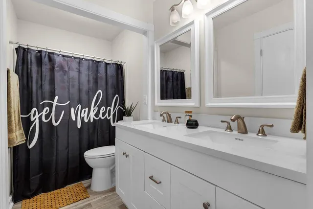 a view of a hallway with a room that has a bed