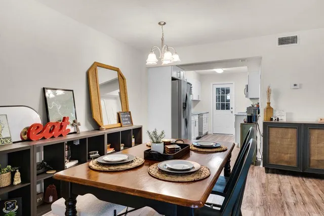 a dining room with furniture and wooden floor