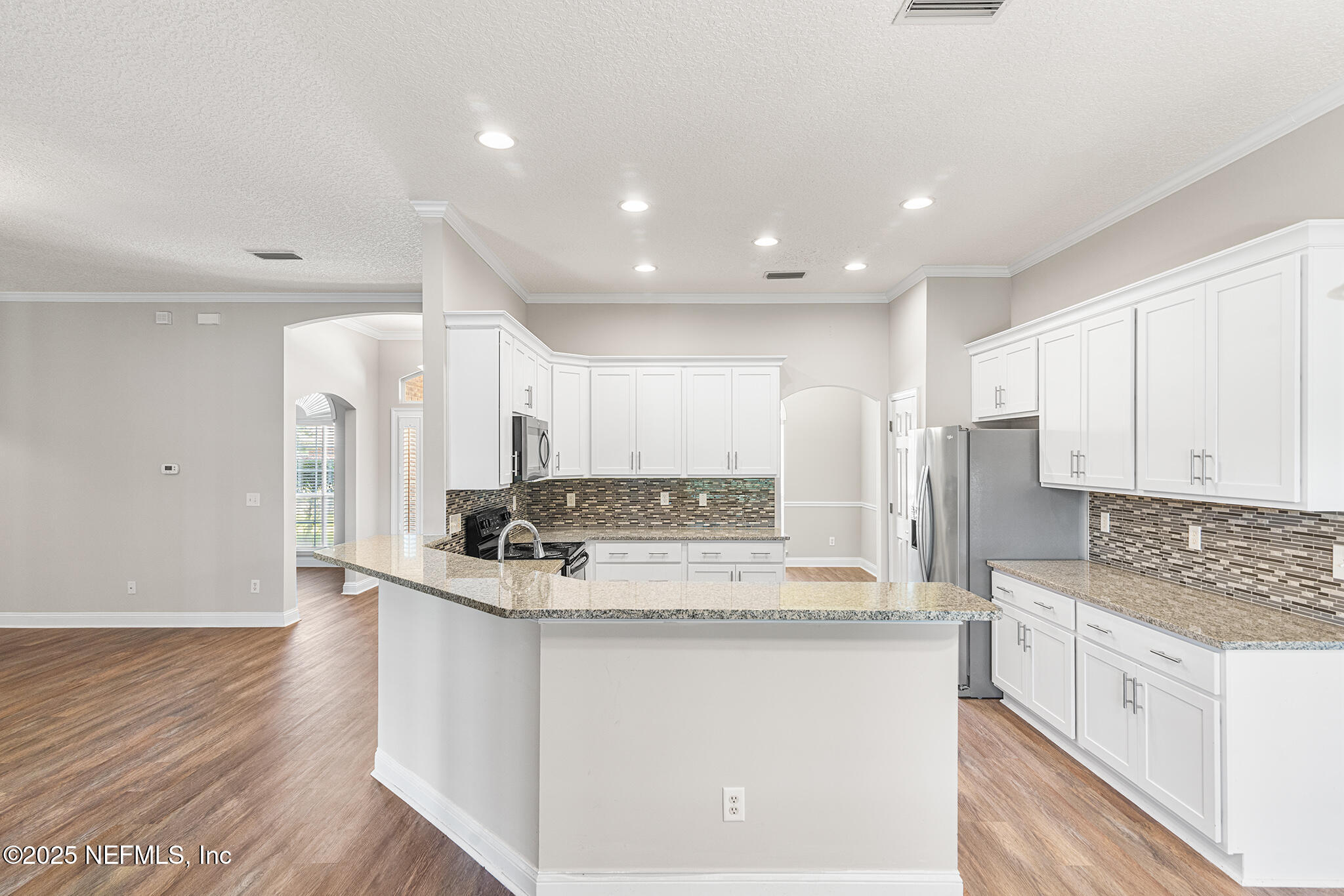 10922 Dunnotar Road Jacksonville, FL 32221 - Photo 11 of 35 a kitchen with stainless steel appliances granite countertop a stove a sink and a refrigerator