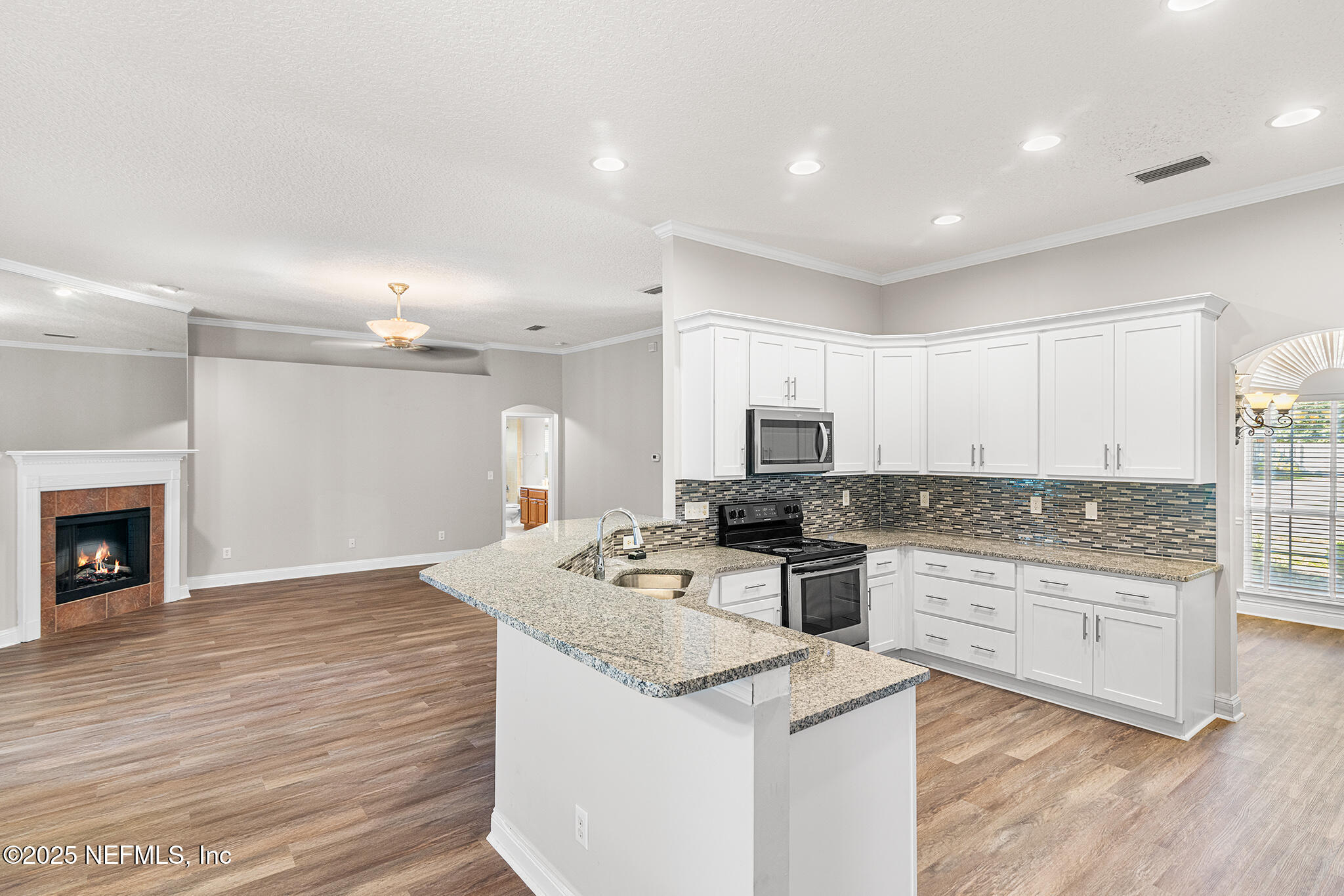 10922 Dunnotar Road Jacksonville, FL 32221 - Photo 12 of 35 a kitchen with a stove a sink and a refrigerator
