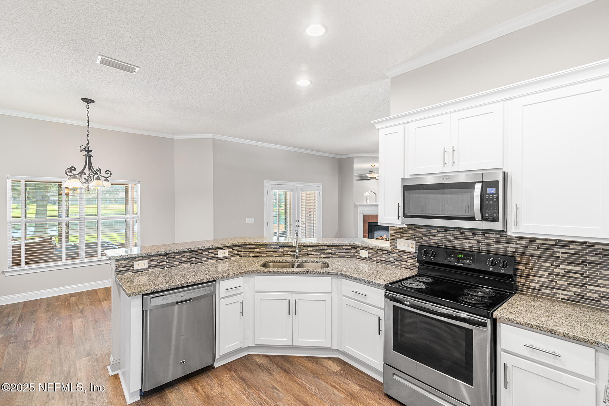 10922 Dunnotar Road Jacksonville, FL 32221 - Photo 13 of 35 a kitchen with granite countertop a stove sink and microwave