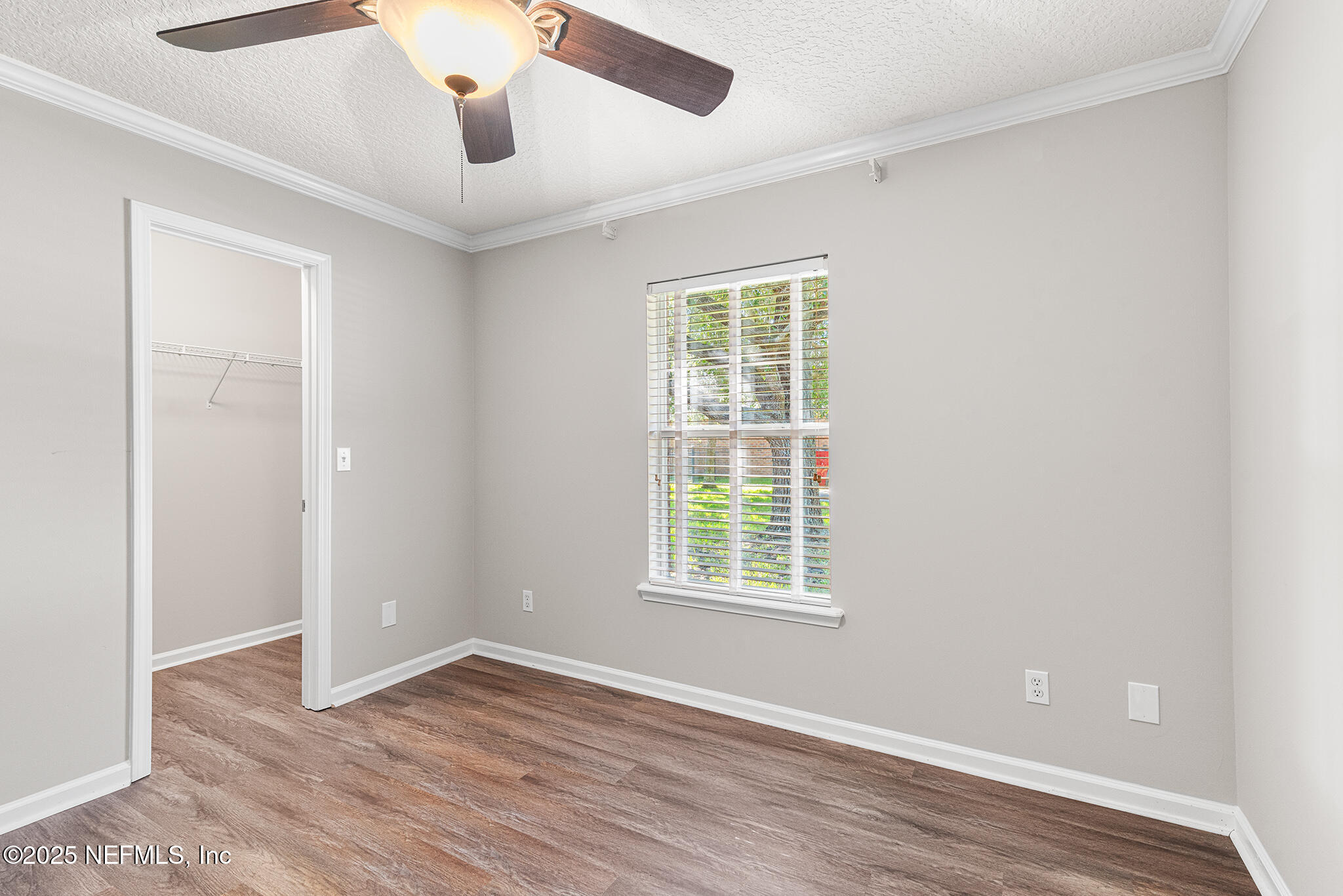 10922 Dunnotar Road Jacksonville, FL 32221 - Photo 19 of 35 an empty room with wooden floor cabinet and windows