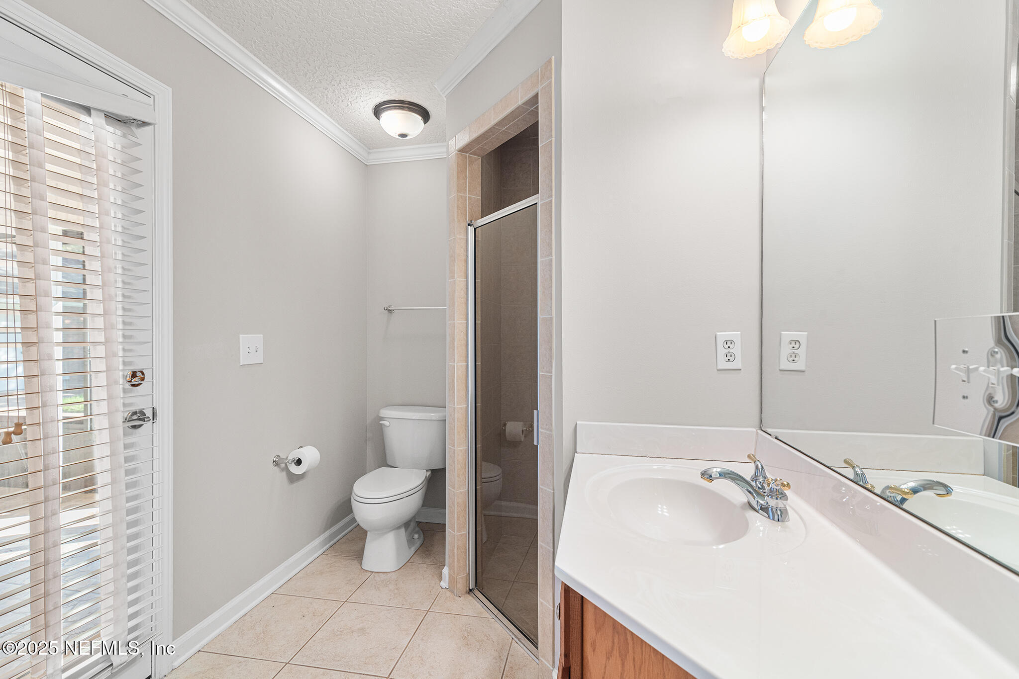 10922 Dunnotar Road Jacksonville, FL 32221 - Photo 20 of 35 a bathroom with a sink a toilet a shower and a mirror