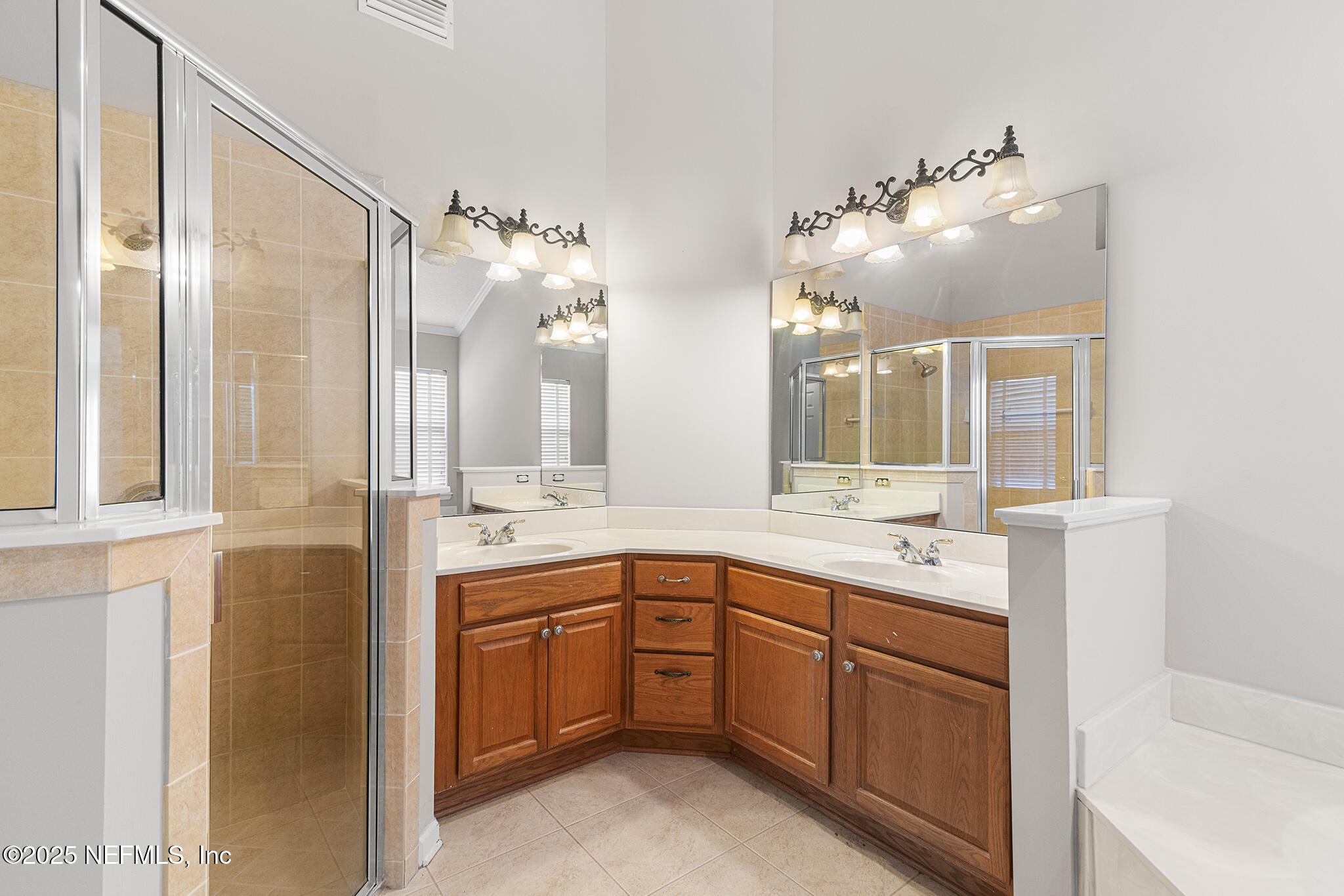 10922 Dunnotar Road Jacksonville, FL 32221 - Photo 24 of 35 a bathroom with a double vanity sink and mirror with bathtub