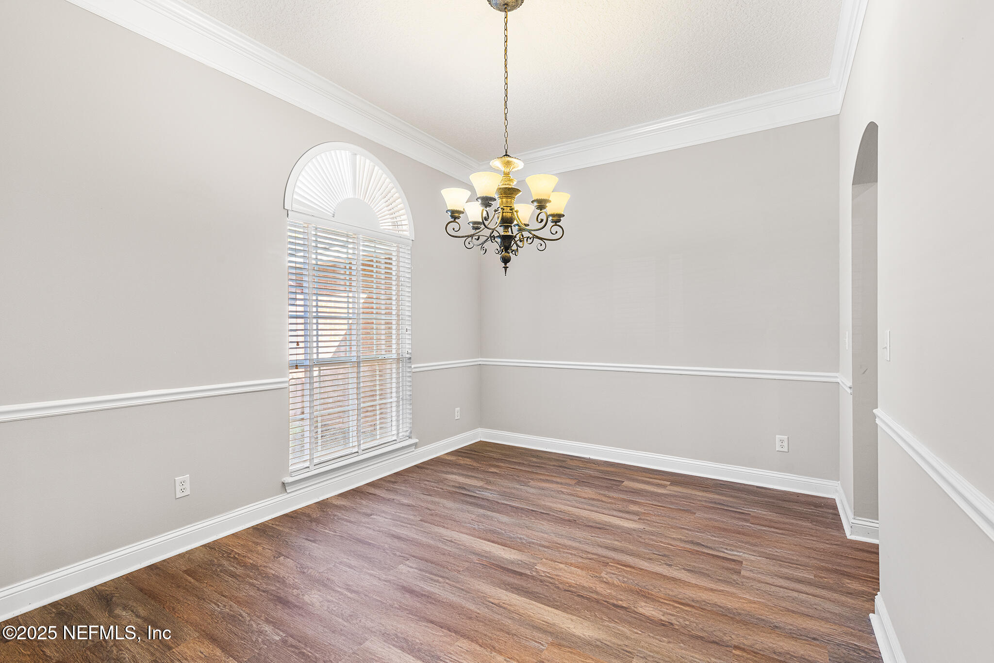10922 Dunnotar Road Jacksonville, FL 32221 - Photo 6 of 35 a view of a room with wooden floor and chandelier