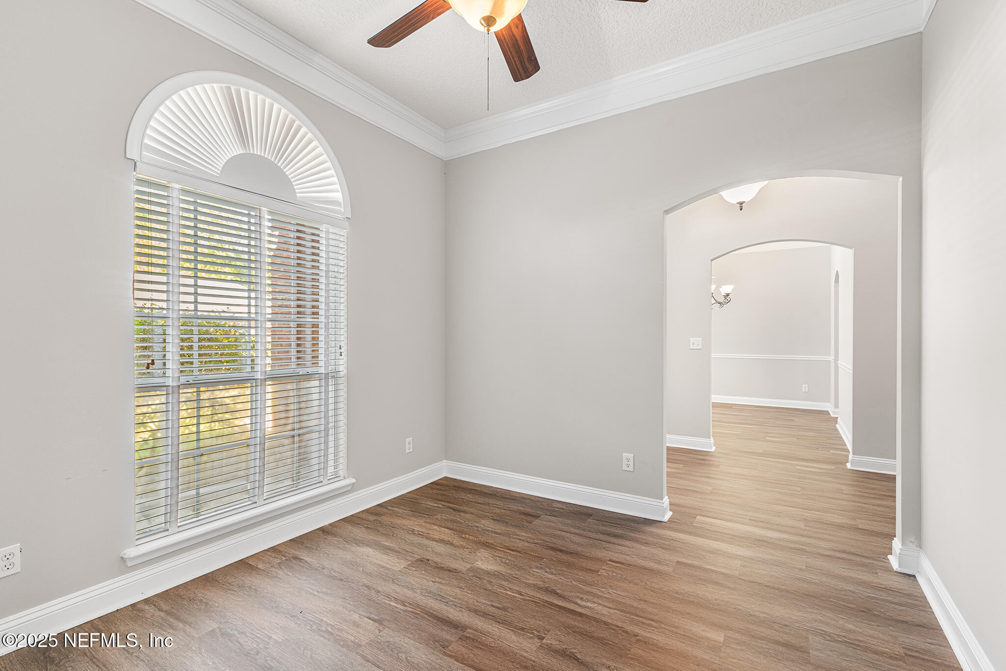 10922 Dunnotar Road Jacksonville, FL 32221 - Photo 7 of 35 a view of empty room with wooden floor and fan