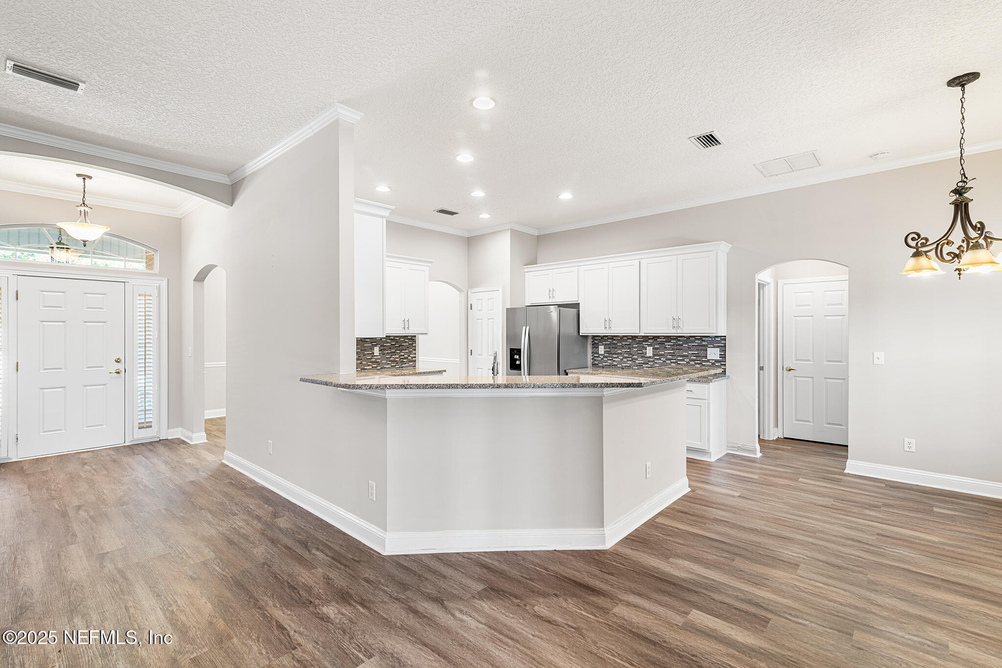 10922 Dunnotar Road Jacksonville, FL 32221 - Photo 9 of 35 a kitchen with stainless steel appliances a refrigerator sink and cabinets