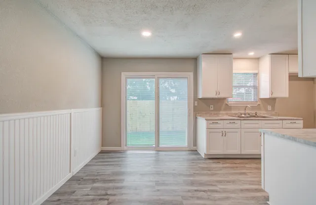 a view of a kitchen with a sink and a stove top oven